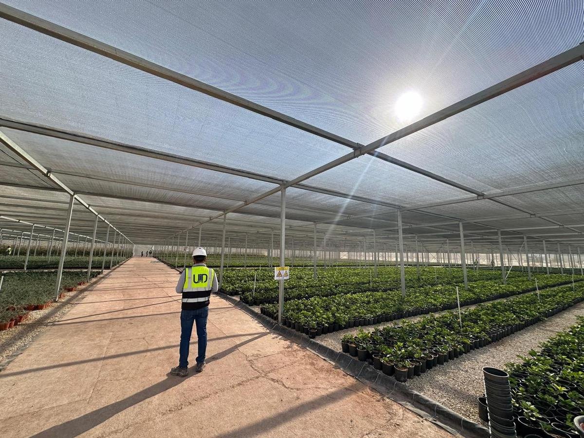 UID engineer inspecting a greenhouse structure