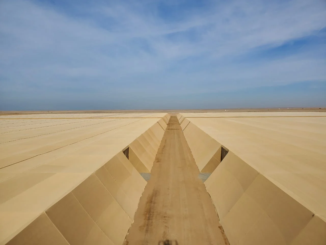 Net house roofing stretching across the desert